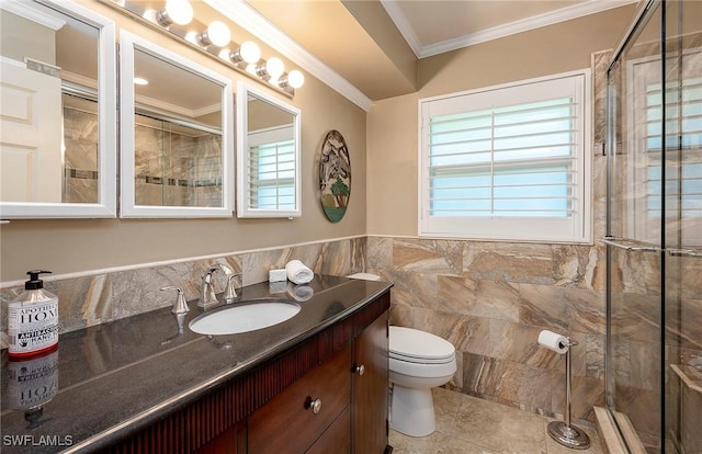 bathroom featuring toilet, ornamental molding, tile walls, vanity, and tiled shower