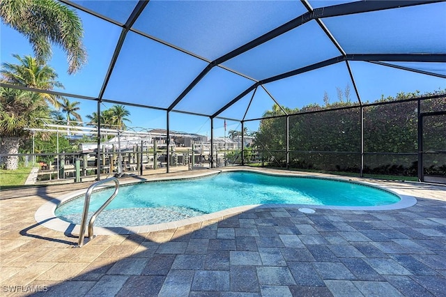 outdoor pool featuring a patio and glass enclosure