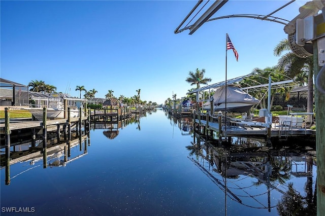 dock area featuring boat lift and a water view