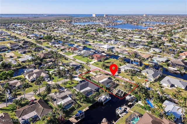 birds eye view of property with a residential view and a water view