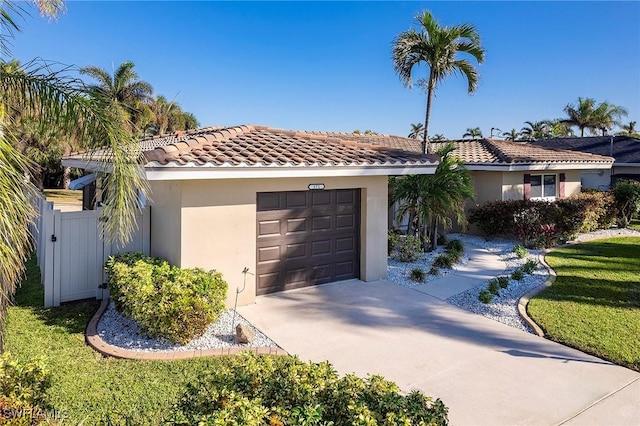 view of front of home featuring a tile roof, concrete driveway, a garage, and stucco siding