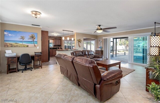 living room with visible vents, ornamental molding, ceiling fan, and light tile patterned floors