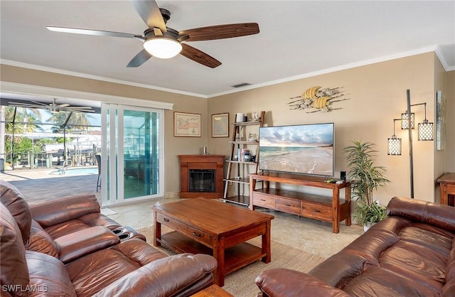 living area with light tile patterned flooring, a ceiling fan, and crown molding