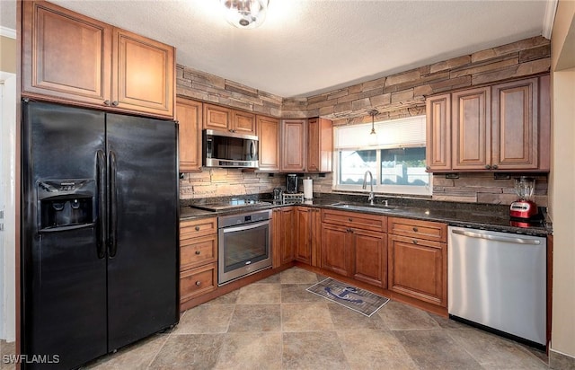 kitchen featuring backsplash, a sink, appliances with stainless steel finishes, and brown cabinetry