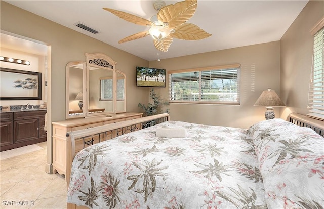 bedroom featuring visible vents, ceiling fan, light tile patterned flooring, and a sink