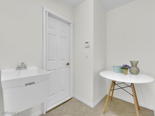 7539 Berkshire Pines Dr, Naples, FL 34104 - bathroom featuring a sink, baseboards, and tile patterned flooring