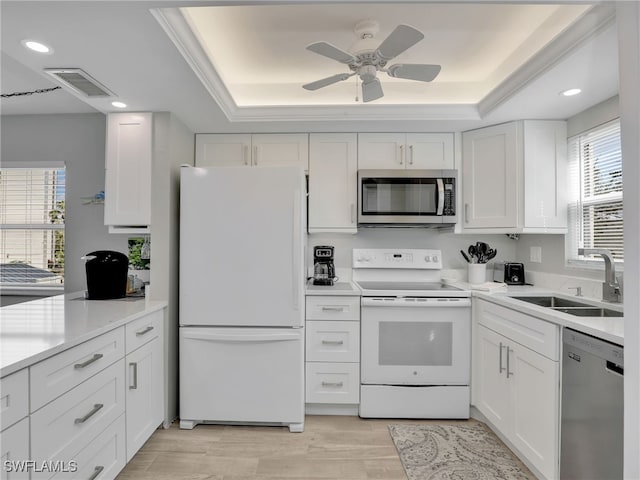 6893 Estero Blvd Unit 416, Fort Myers Beach, FL 33931 - kitchen featuring stainless steel appliances, a raised ceiling, healthy amount of natural light, white cabinets, and recessed lighting