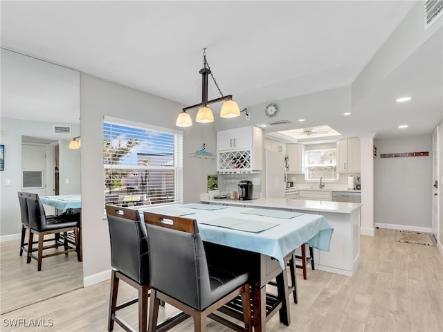 6893 Estero Blvd Unit 416, Fort Myers Beach, FL 33931 - dining area with light wood-type flooring, recessed lighting, and a raised ceiling