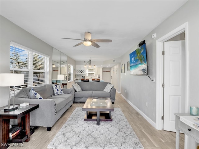 6893 Estero Blvd Unit 416, Fort Myers Beach, FL 33931 - living room featuring a ceiling fan, light wood finished floors, and a chandelier