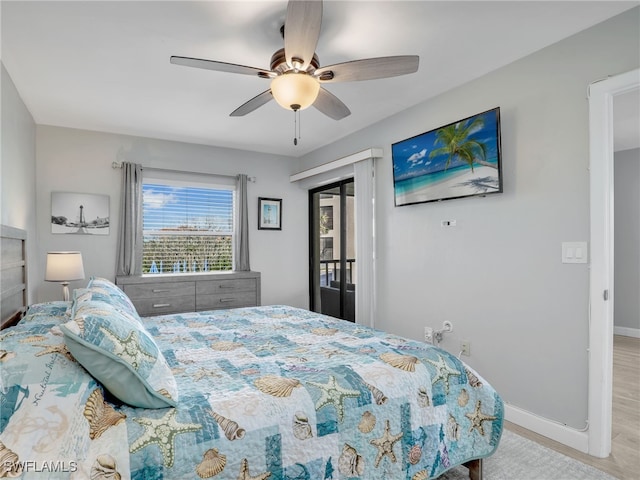 bedroom featuring a ceiling fan, baseboards, and wood finished floors