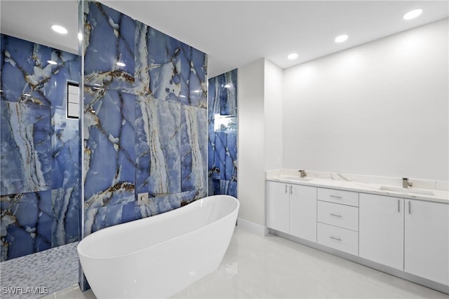 full bathroom with recessed lighting, double vanity, a sink, and a soaking tub