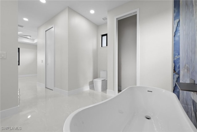 full bathroom featuring baseboards, recessed lighting, and a freestanding bath