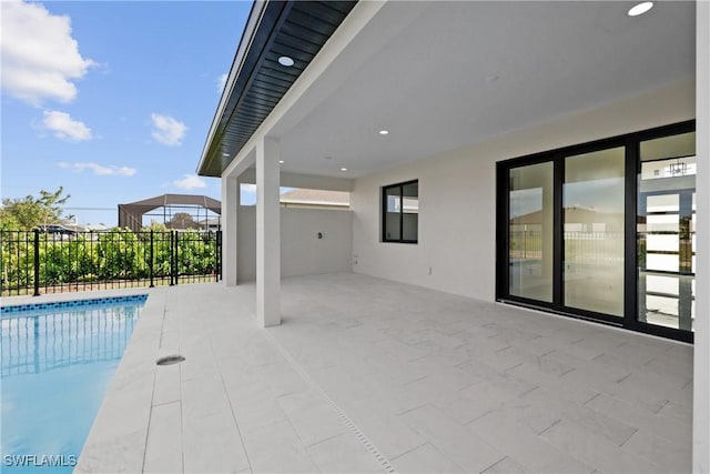 pool with fence and a patio