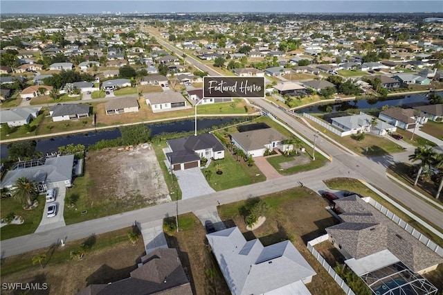 drone / aerial view with a residential view and a water view
