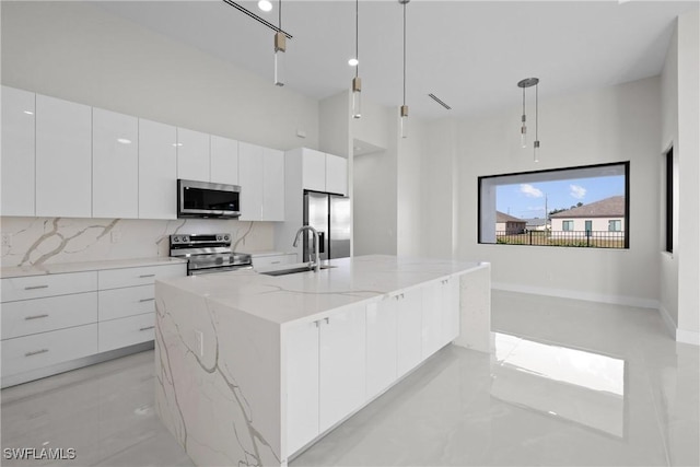 kitchen featuring a sink, modern cabinets, white cabinetry, and stainless steel appliances
