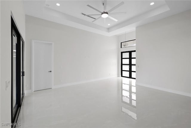 empty room with baseboards, recessed lighting, a raised ceiling, and ceiling fan
