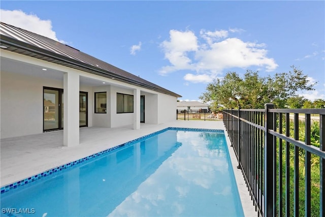 view of pool with a patio, a fenced in pool, and fence