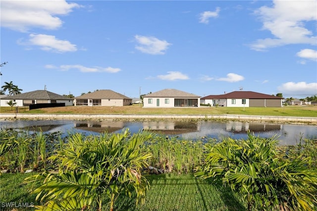 view of yard with a residential view and a water view