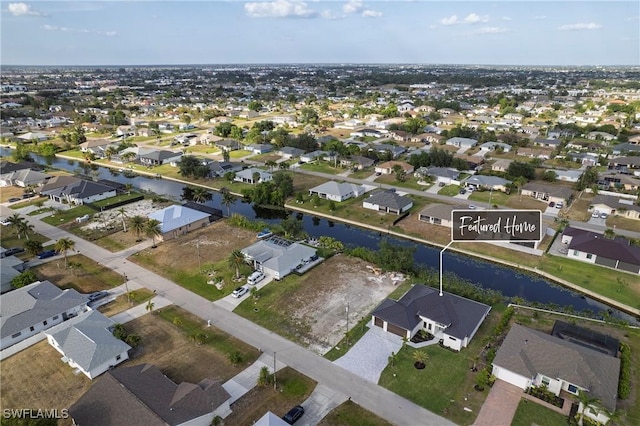bird's eye view featuring a residential view and a water view