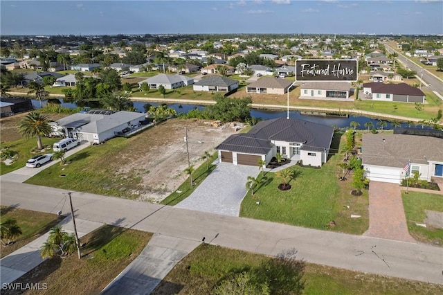 drone / aerial view with a water view and a residential view