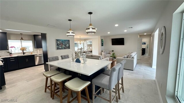 dining area featuring baseboards, a notable chandelier, recessed lighting, and visible vents