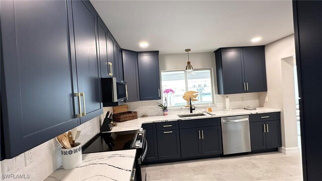 kitchen with decorative light fixtures, tasteful backsplash, light stone countertops, a sink, and stainless steel appliances