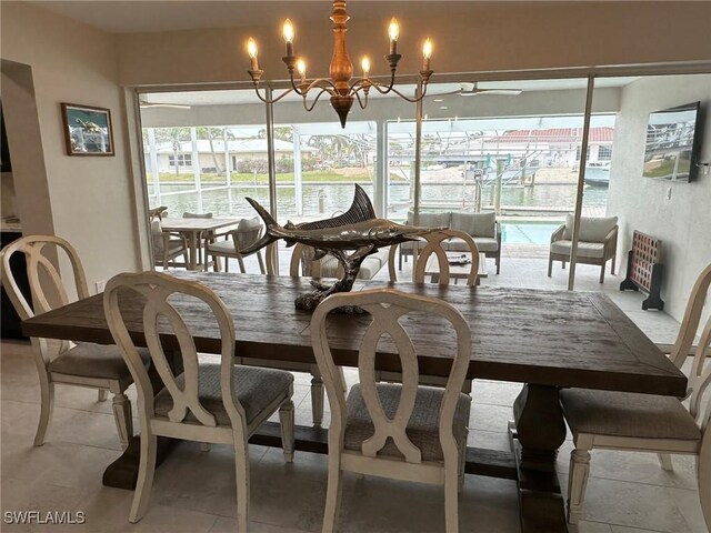 dining area with light tile patterned floors, a chandelier, and a wealth of natural light