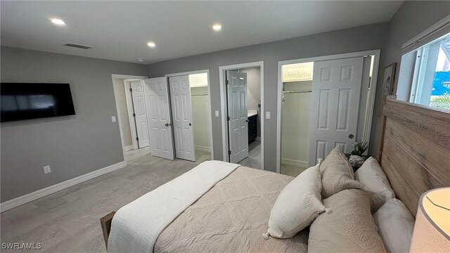 bedroom featuring visible vents, recessed lighting, baseboards, and two closets