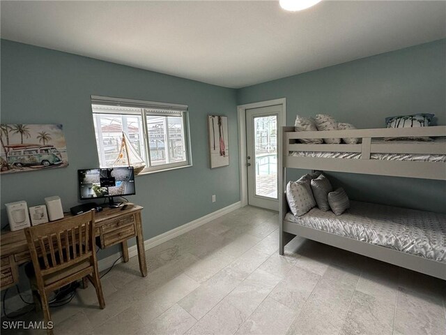 bedroom with baseboards and access to exterior