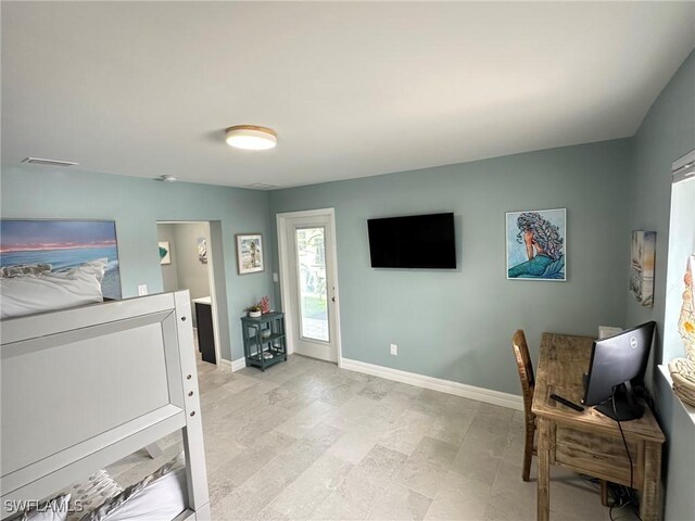 living area with visible vents and baseboards
