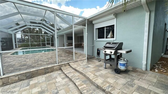 view of patio with a lanai, area for grilling, and an outdoor pool