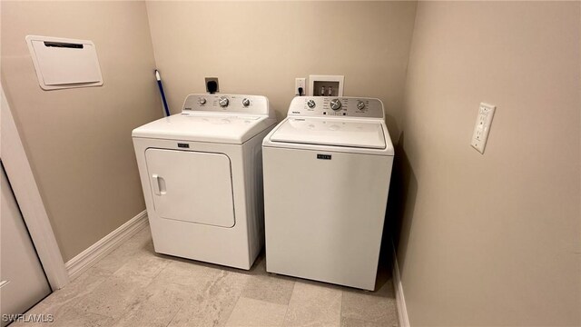 washroom with independent washer and dryer, laundry area, and baseboards