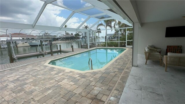 pool with a boat dock, boat lift, glass enclosure, and a patio
