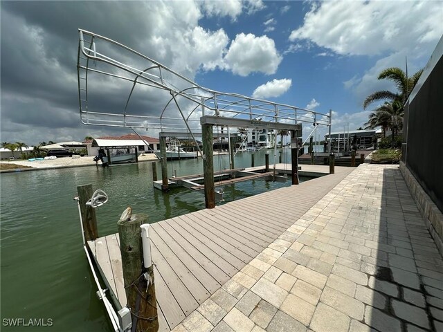 view of dock featuring a water view and boat lift