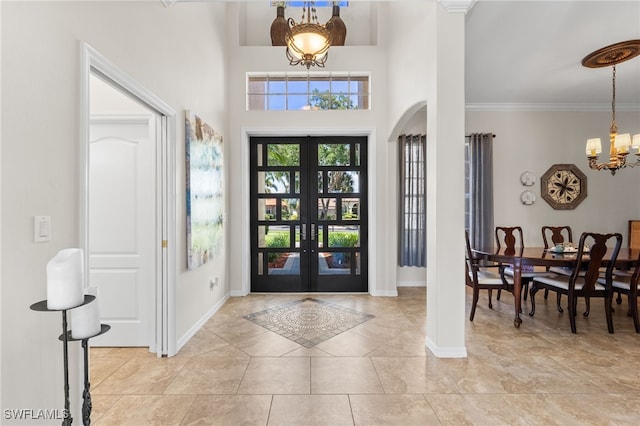 14790 Fripp Island Ct, Naples, FL 34119 - entryway with a chandelier, french doors, arched walkways, baseboards, and crown molding