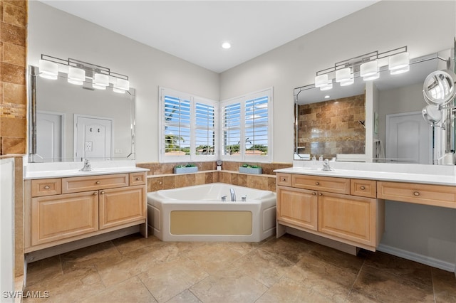 14790 Fripp Island Ct, Naples, FL 34119 - bathroom featuring tiled shower, a garden tub, two vanities, stone finish floors, and recessed lighting