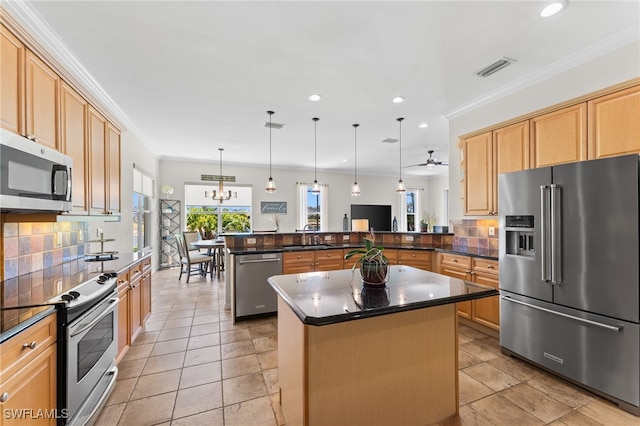 14790 Fripp Island Ct, Naples, FL 34119 - kitchen with stainless steel appliances, a peninsula, a sink, a center island, and tasteful backsplash