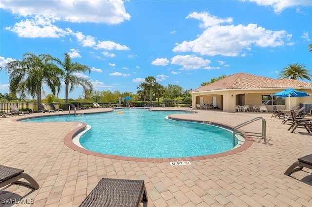 pool featuring a patio and fence