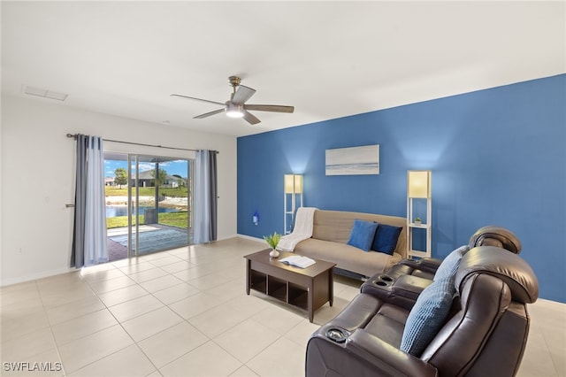 living area featuring light tile patterned floors, ceiling fan, visible vents, and baseboards