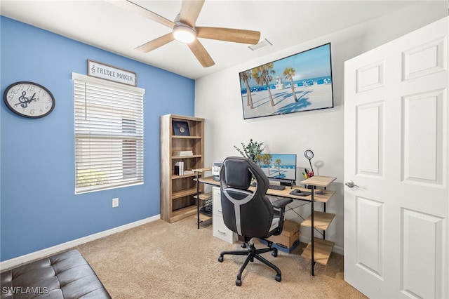 carpeted home office featuring baseboards, ceiling fan, and visible vents