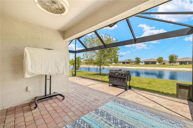 sunroom featuring a water view