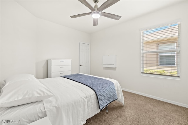 carpeted bedroom with baseboards, ceiling fan, and multiple windows