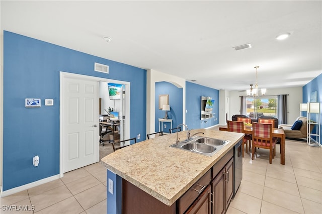 kitchen featuring visible vents, dishwasher, open floor plan, a sink, and light tile patterned floors