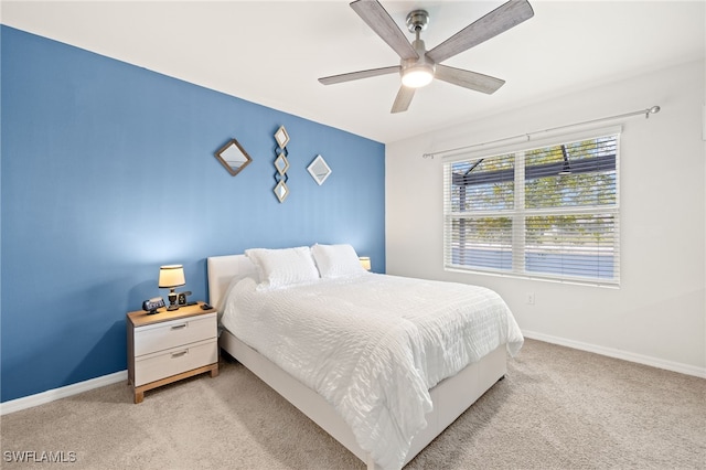 bedroom featuring baseboards, a ceiling fan, and light carpet
