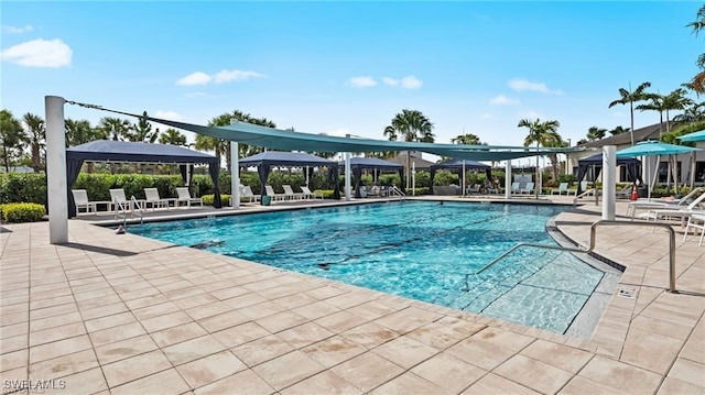 pool with a gazebo and a patio area