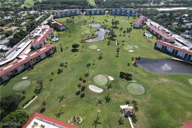 drone / aerial view with golf course view and a water view