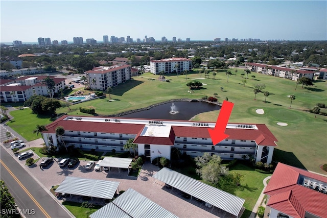 birds eye view of property with a view of city, golf course view, and a water view