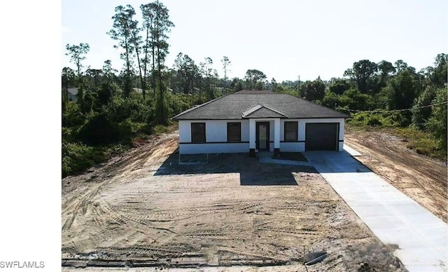 463 Latic Ave S, Lehigh Acres, FL 33974 - view of front facade with driveway and an attached garage