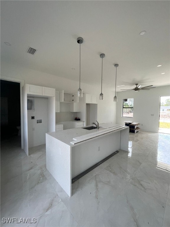 463 Latic Ave S, Lehigh Acres, FL 33974 - kitchen with white cabinets, a ceiling fan, light marble finish flooring, and hanging light fixtures
