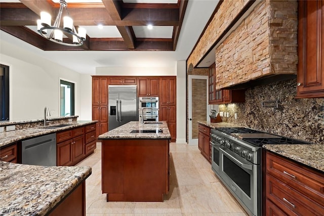 kitchen with a center island with sink, high quality appliances, a sink, coffered ceiling, and a notable chandelier